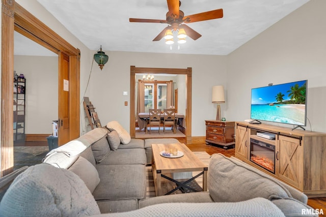 living area with light wood-type flooring and a ceiling fan