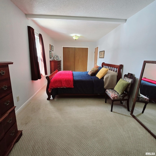 carpeted bedroom with beam ceiling, a textured ceiling, and baseboards