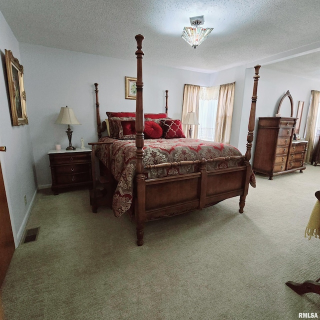 bedroom with a textured ceiling, baseboards, visible vents, and light colored carpet