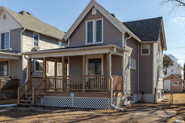 view of front of house with covered porch and a shingled roof