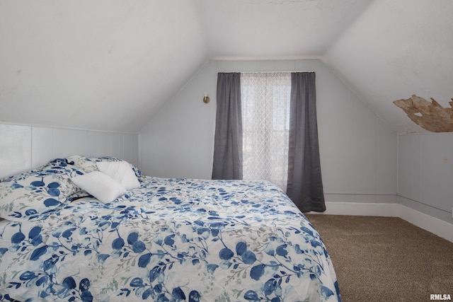 bedroom with lofted ceiling and carpet flooring