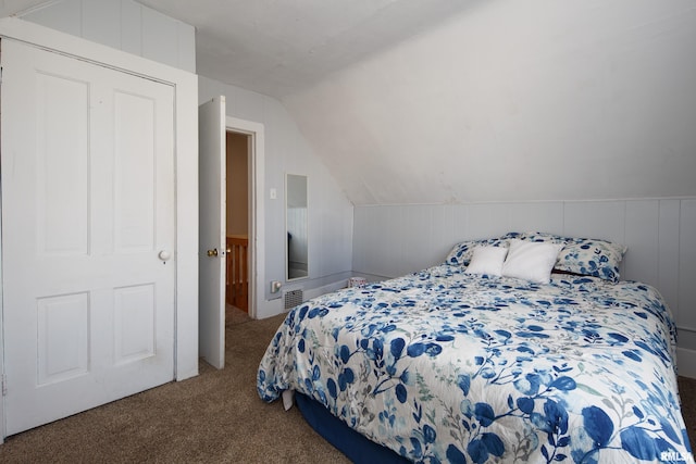 bedroom featuring visible vents, vaulted ceiling, and carpet flooring