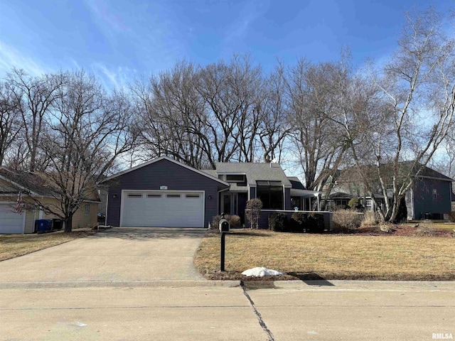 ranch-style house featuring a garage, concrete driveway, and a front lawn