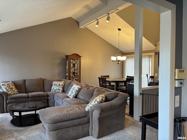 carpeted living room featuring a chandelier, rail lighting, and vaulted ceiling