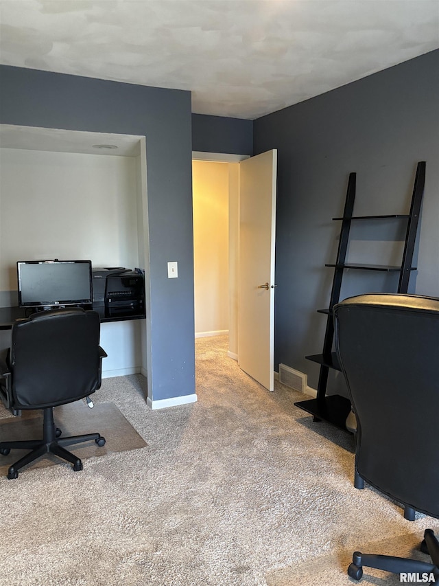 office featuring carpet, visible vents, and baseboards