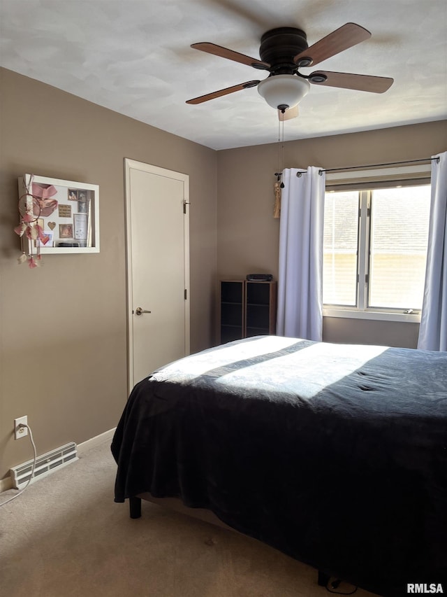 bedroom featuring carpet floors, baseboards, visible vents, and a ceiling fan