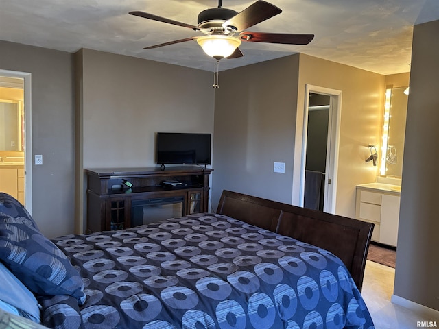 bedroom with ensuite bathroom and ceiling fan