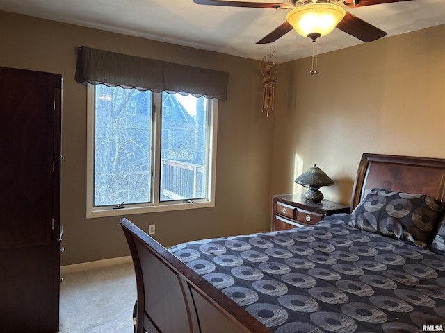 bedroom featuring a ceiling fan, carpet flooring, and baseboards