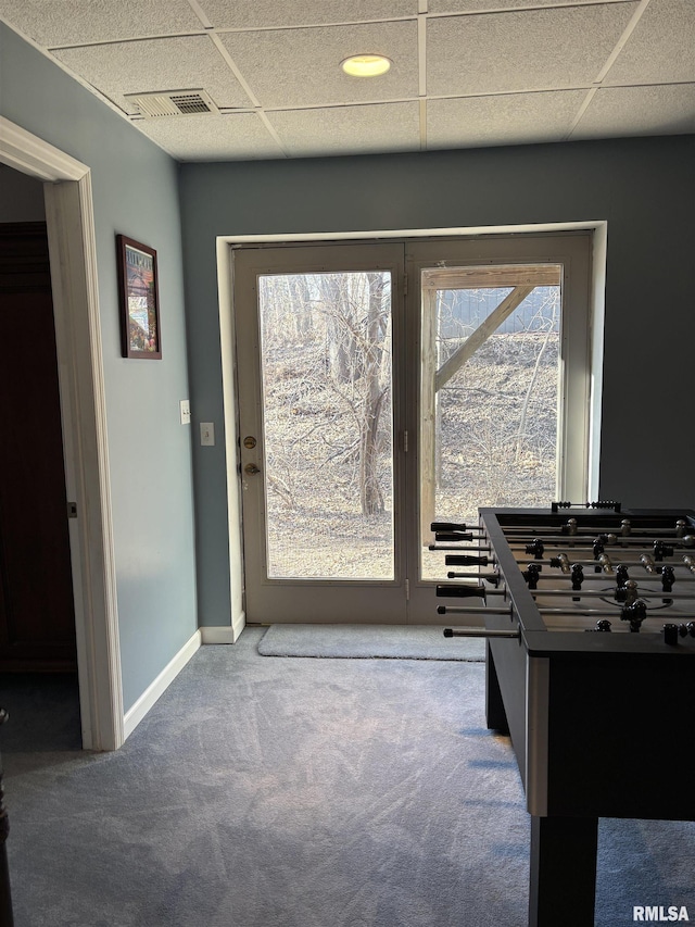 game room featuring a paneled ceiling, carpet, visible vents, and baseboards