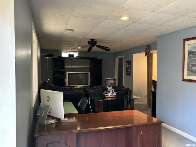 office space with ceiling fan, a paneled ceiling, visible vents, and baseboards