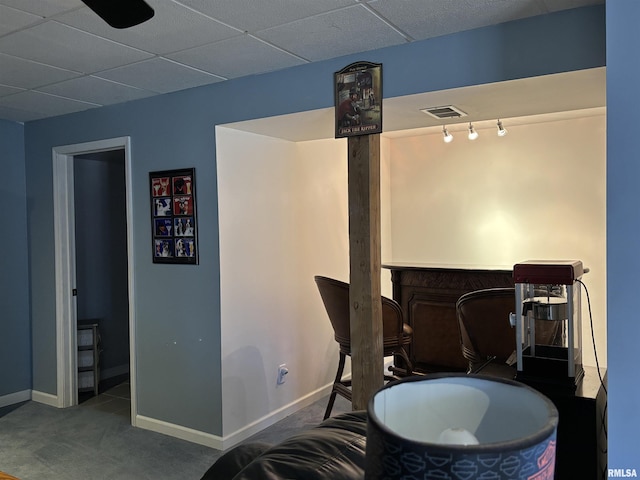 interior space featuring baseboards, visible vents, and carpet flooring