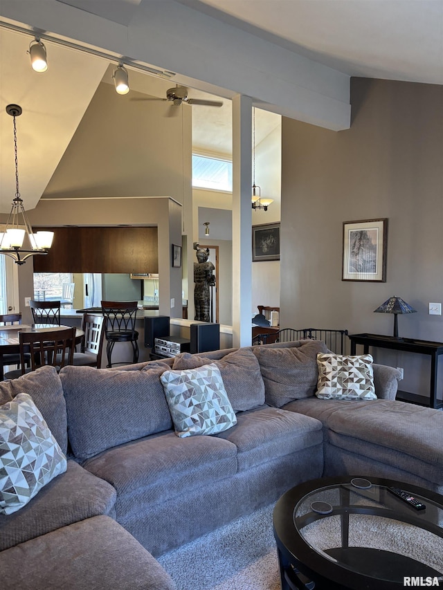 living room with an inviting chandelier and high vaulted ceiling