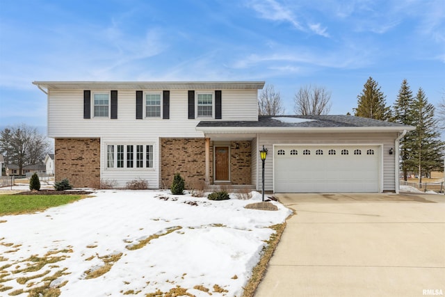 traditional-style house with concrete driveway, brick siding, and an attached garage