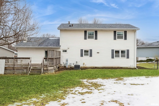 back of property featuring a lawn, cooling unit, and a wooden deck