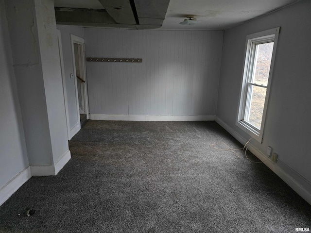 unfurnished room featuring carpet flooring and baseboards