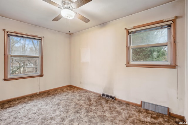 unfurnished room with baseboards, visible vents, ceiling fan, and carpet flooring