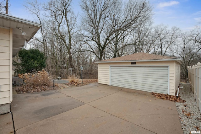 detached garage featuring fence