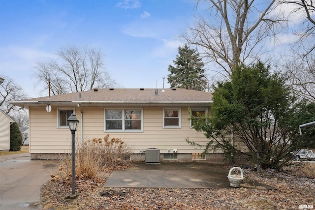 rear view of property featuring central AC and a patio area