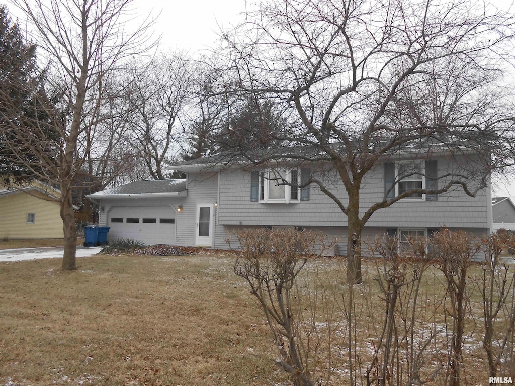 620 Terrace Dr, Blue Grass, IA 52726 - view of side of property featuring a lawn and an attached garage