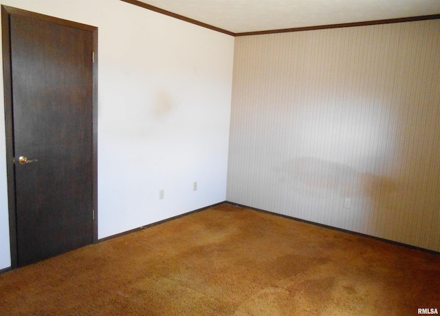 unfurnished room featuring baseboards, ornamental molding, and carpet flooring