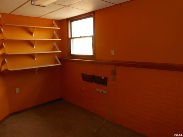 empty room featuring a paneled ceiling