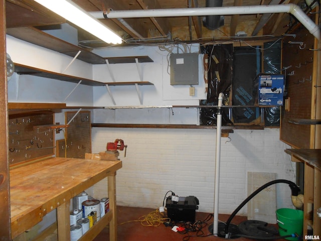 unfinished basement featuring a workshop area and electric panel