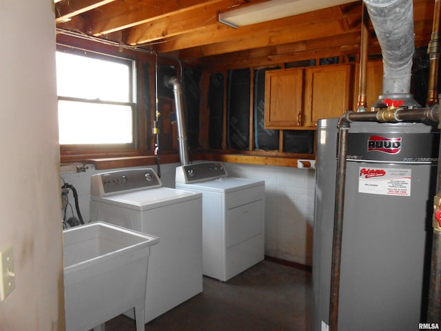 washroom with laundry area, gas water heater, a sink, and separate washer and dryer