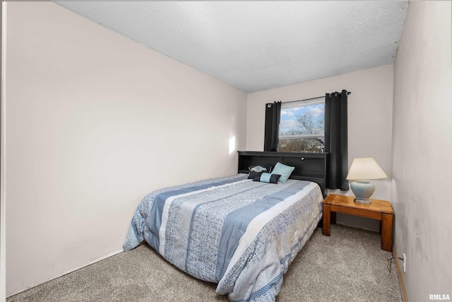 bedroom featuring a textured ceiling and carpet flooring