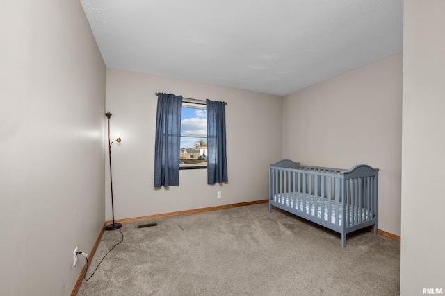 unfurnished bedroom featuring carpet, visible vents, and baseboards