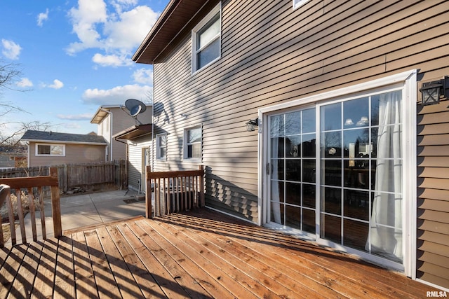 wooden terrace featuring fence and a patio