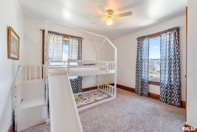 full bathroom featuring curtained shower, toilet, vanity, wainscoting, and stone finish floor