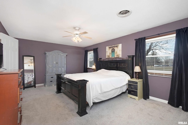 bedroom featuring baseboards, ceiling fan, visible vents, and light colored carpet