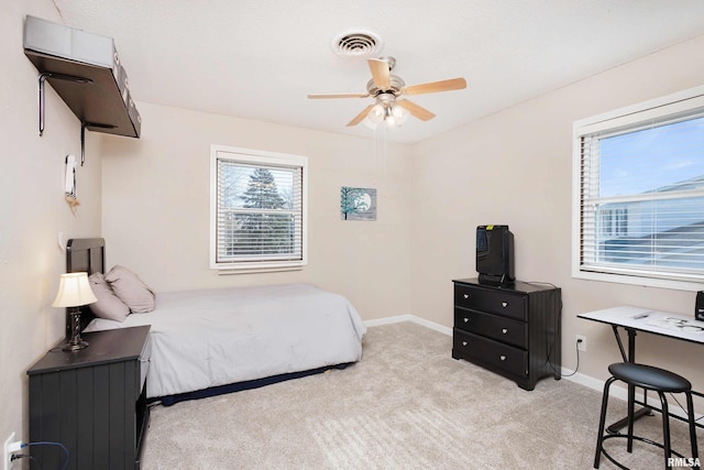 bedroom with light carpet, baseboards, visible vents, and ceiling fan