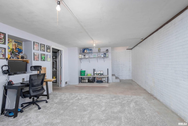 office featuring brick wall and concrete floors