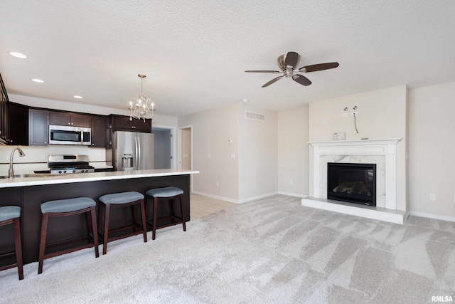 kitchen featuring visible vents, appliances with stainless steel finishes, a kitchen breakfast bar, and light countertops