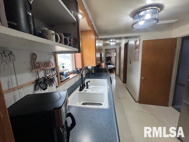 kitchen with brown cabinetry and a sink