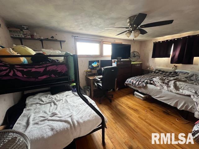 bedroom featuring ceiling fan and wood finished floors