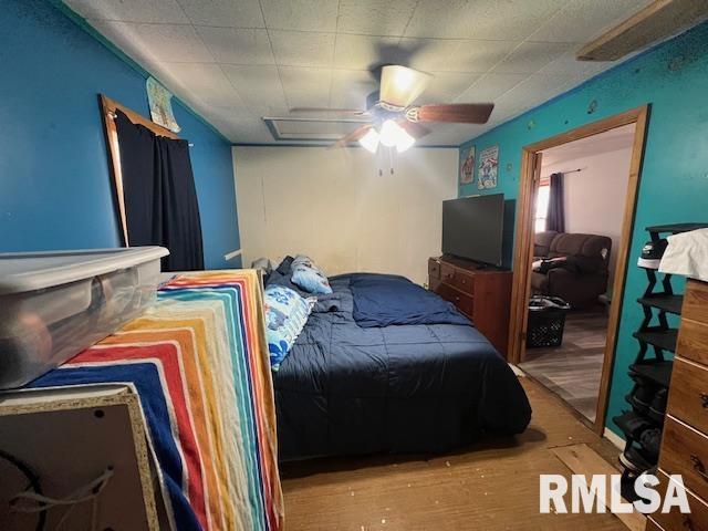 bedroom featuring ceiling fan and wood finished floors