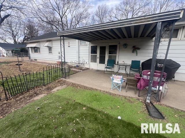 rear view of property with a patio area and fence