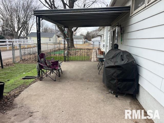 view of patio with an attached carport, fence, and area for grilling