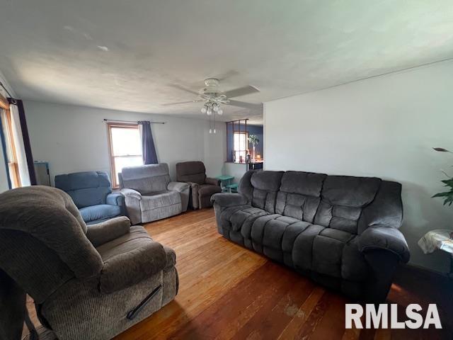 living room with ceiling fan and wood finished floors