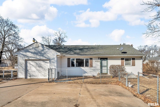 ranch-style home featuring driveway, a fenced front yard, and an attached garage