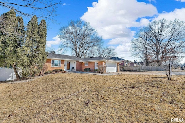 ranch-style home with a garage, driveway, brick siding, and fence