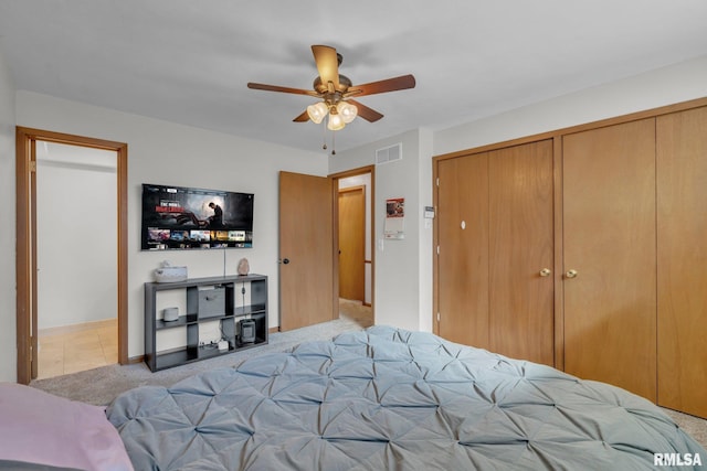 carpeted bedroom with ceiling fan and visible vents