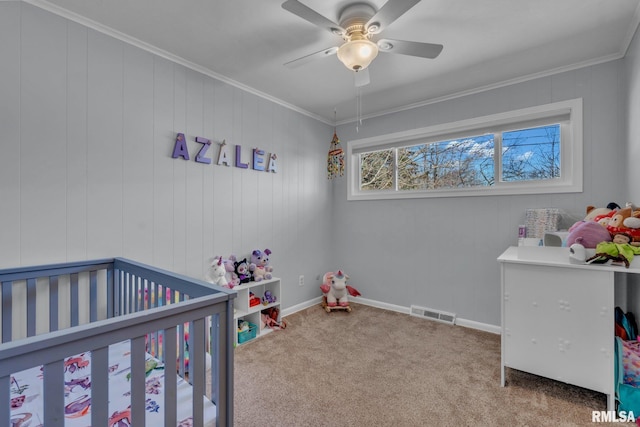 carpeted bedroom featuring a ceiling fan, visible vents, crown molding, and baseboards