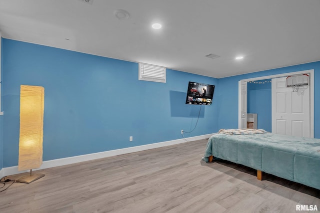 bedroom featuring recessed lighting, a closet, baseboards, and wood finished floors