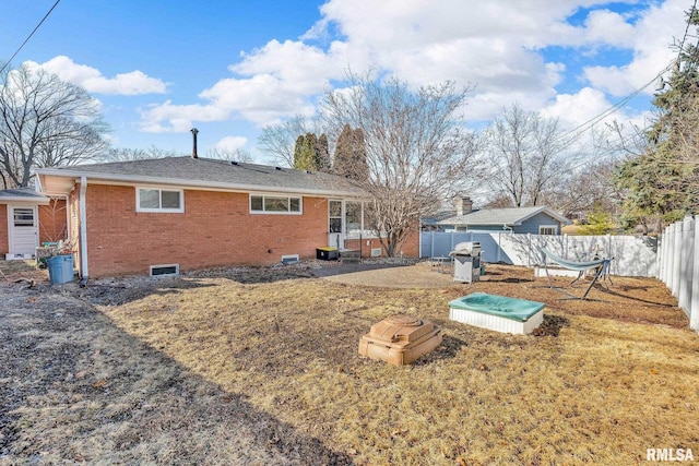 back of house featuring a patio area, brick siding, and a fenced backyard