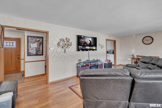 living room featuring light wood-type flooring and baseboards