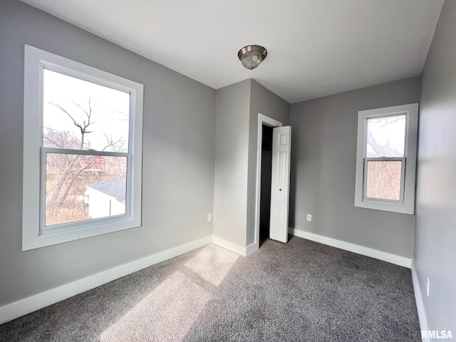 unfurnished bedroom featuring carpet and baseboards