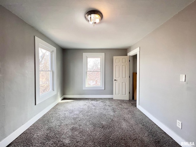 empty room with carpet flooring and baseboards